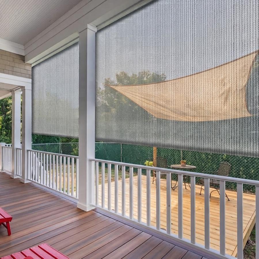 Light grey roll-up shade over a west-facing deck door