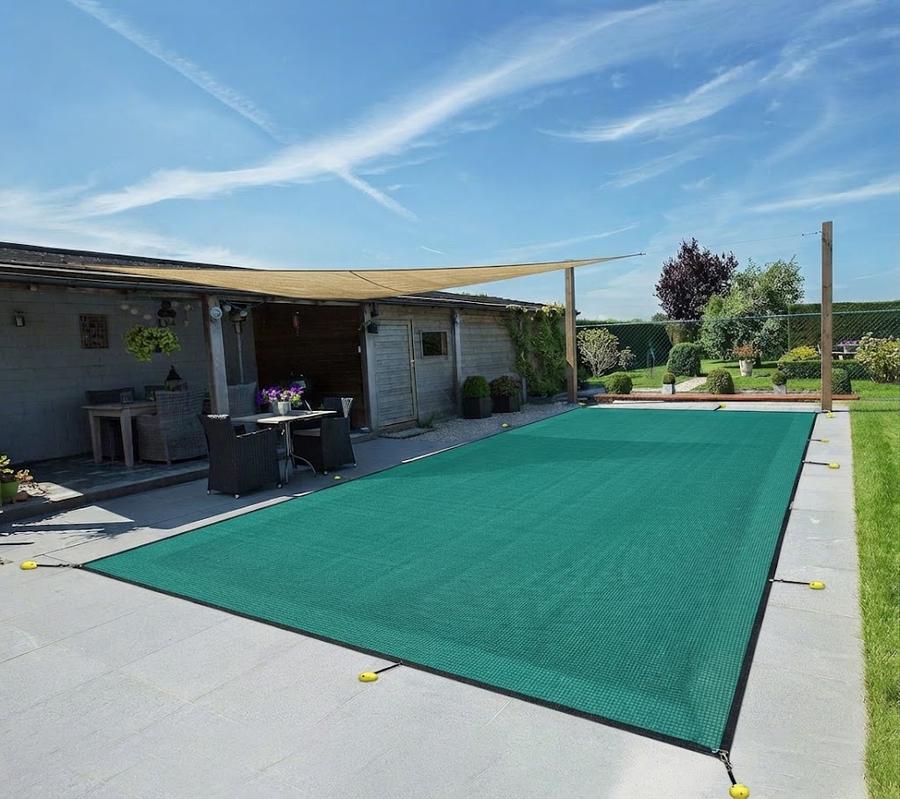 Turquoise green mesh cover stretched over an inground pool